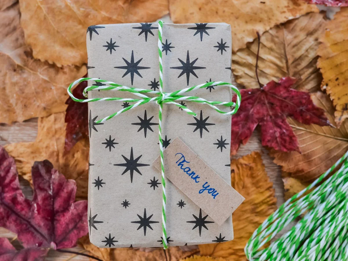 A wrapped gift with a small handwritten thank-you tag.