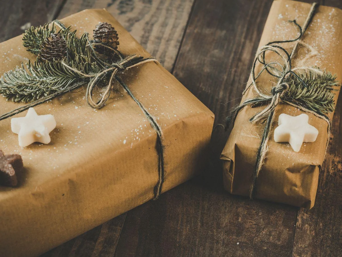 Two gifts wrapped in kraft paper and tied with twine.