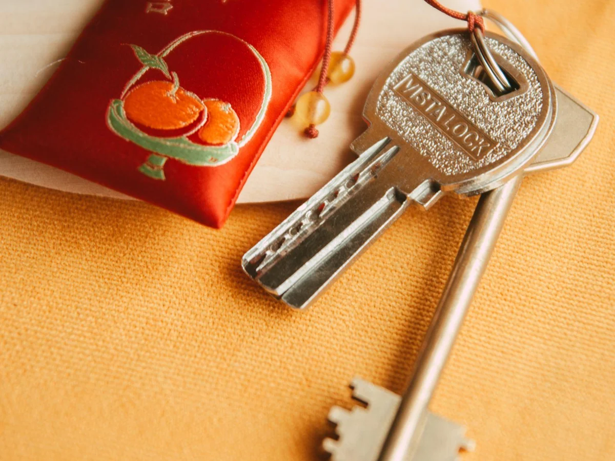 Keys attached to a metal split ring beside a red tag.